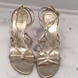 Stuart Weitzman gold strappy heels.